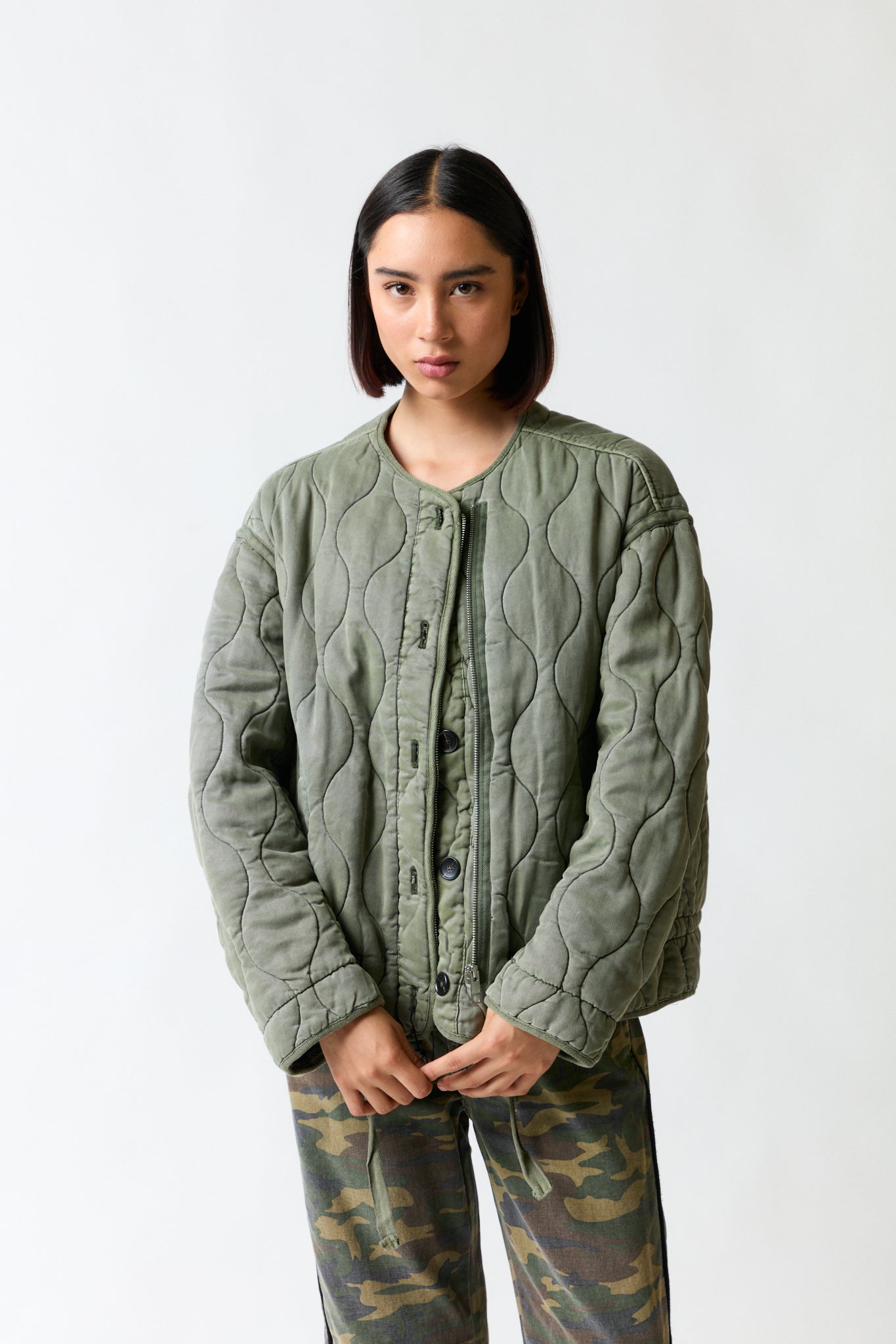 mujer vistiendo chaqueta verde Zara, estilo urbano en estudio