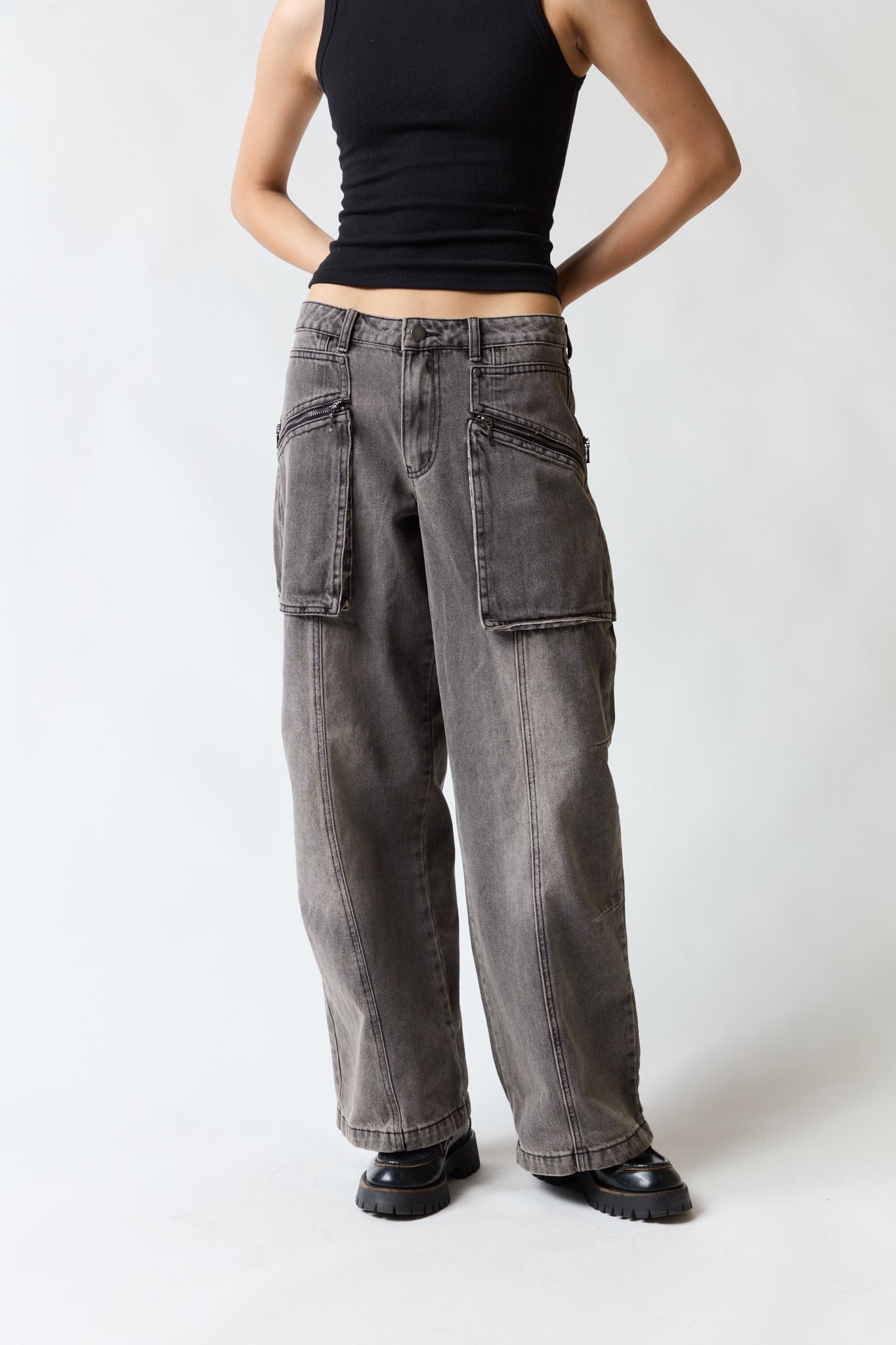 mujer vistiendo pantalón denim gris Umbrale, estilo urbano en estudio