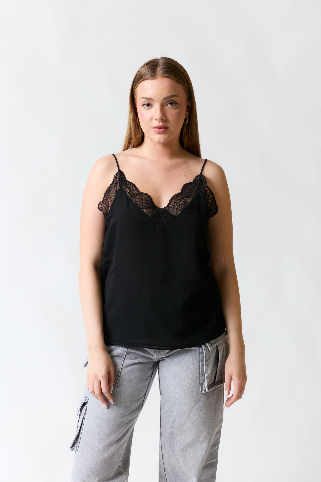 mujer vistiendo polera negro Zara, estilo urbano en estudio