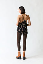 Polera vuelitos negro con dorado | Rapsodia