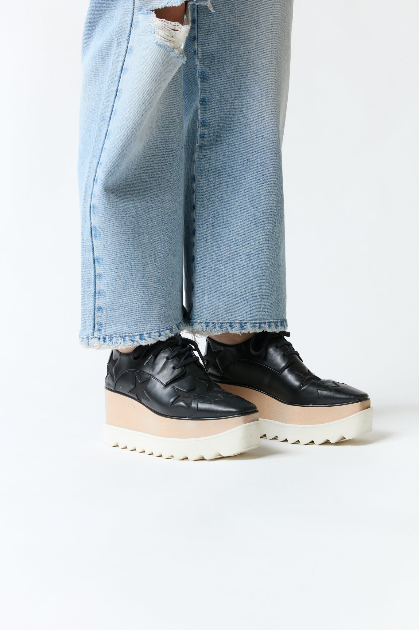 mujer vistiendo producto negro Stella McCartney, estilo urbano en estudio